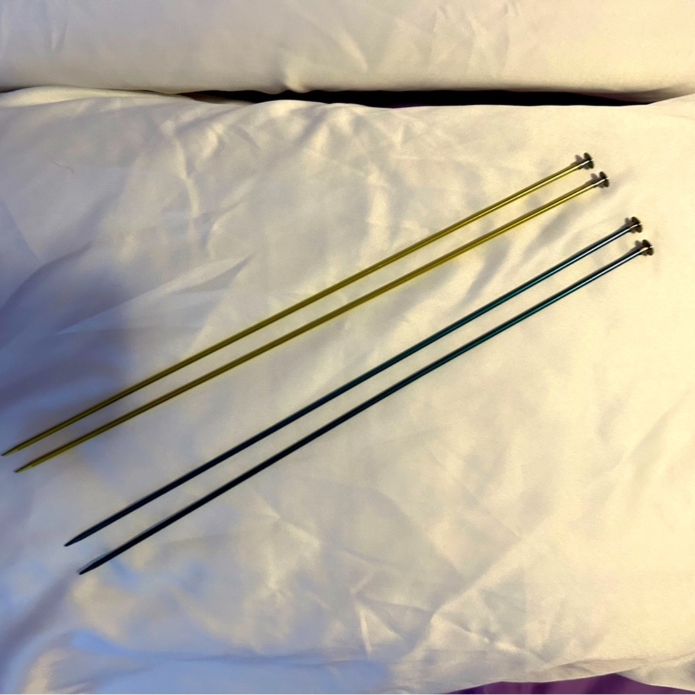 2 pairs of aluminum knitting needles. Both pairs are size 3.